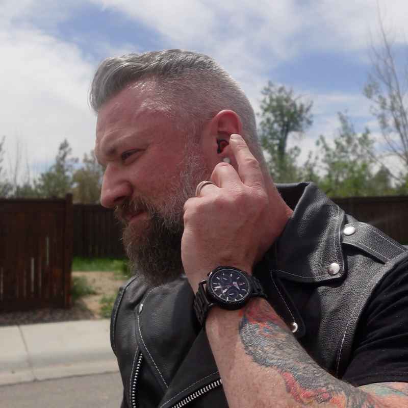 Motorcyclist fitting a Bastion earplug