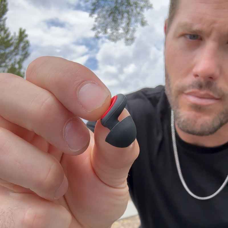 Rider holding a Bastion moto earplug