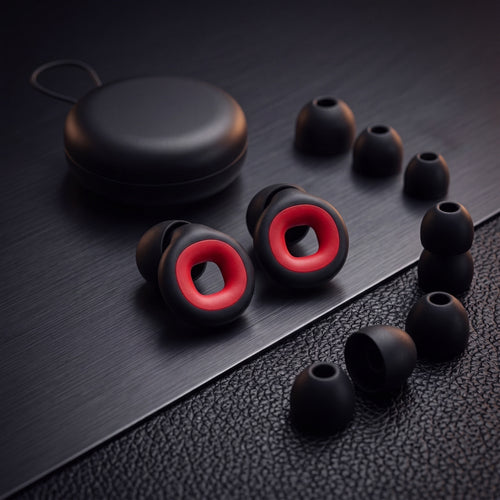 Bastion moto earplugs, travel case and ear-tips on a dark premium surface