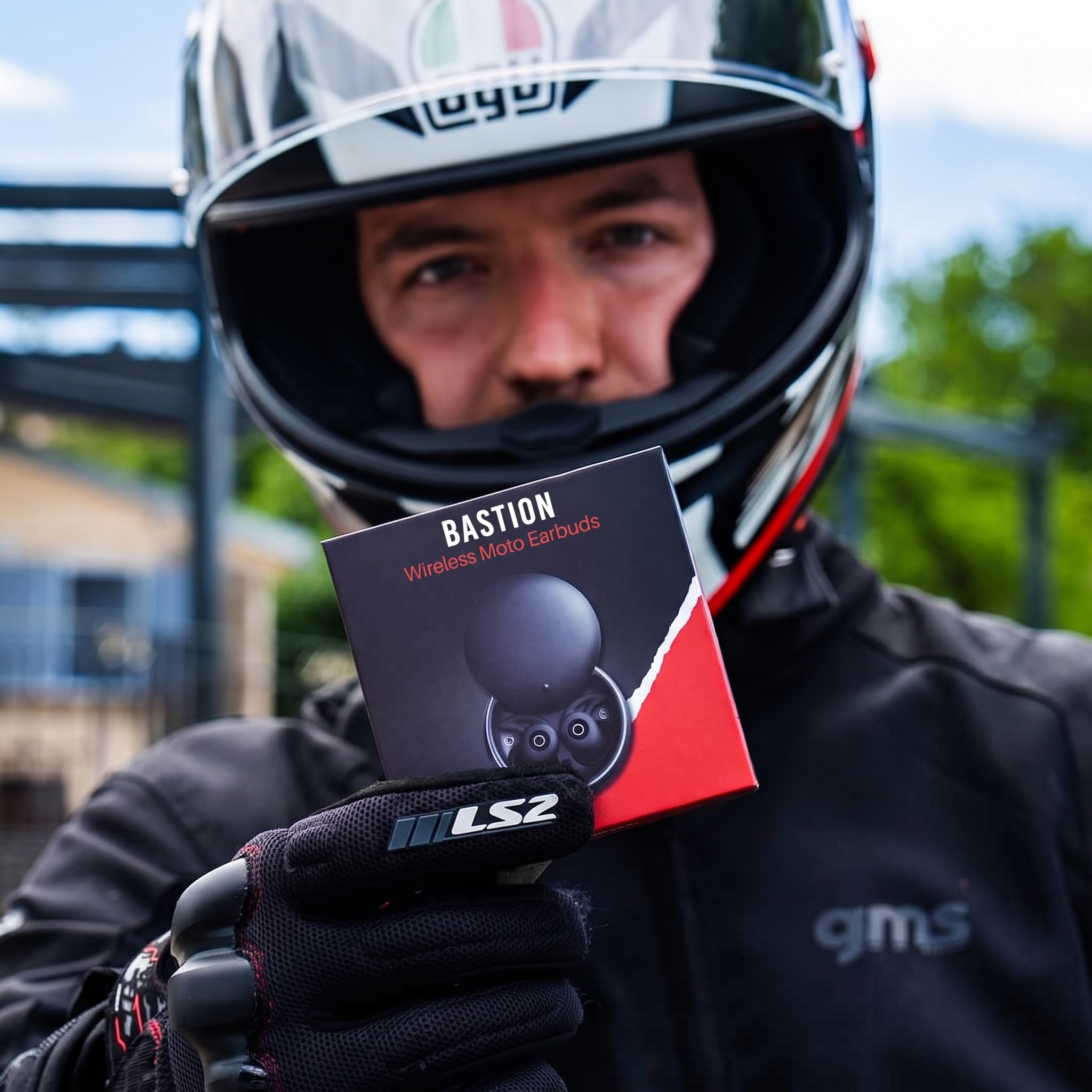 Bastion Bluetooth Moto Earbuds packaging held by a rider